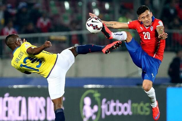 SANTIAGO, June 11, 2015 -- Charles Aranguiz (R) of Chile vies for the ball with Enner Valencia from Ecuador during the opening match of the Copa America 2015, in Santiago, capital of Chile, on June 11, 2015. Chile won 1-0. 