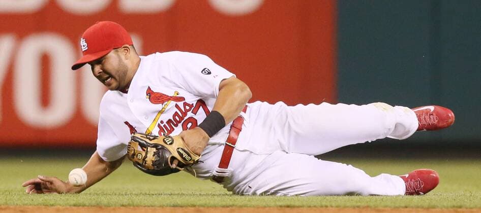 June 12, 2015 - St Louis, MO, USA - St. Louis Cardinals shortstop Jhonny Peralta loses his hold on the ball as the Kansas City Royals Mike Moustakas reaches with a single in the sixth inning on Friday, June 12, 2015, at Busch Stadium in St. Louis. Kansas City at St. Louis - ZUMAm67_