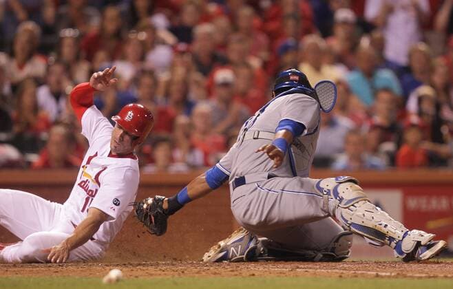 St. Louis Cardinals Randal Grichuk slides into home plate past the tag of Kansas City Royals catcher Salvador Perez on a sacrifice fly ball in the eighth inning at Busch Stadium in St. Louis on June 12, 2015. St. Louis won the game 4-0.  SLP2015061210 BILLxGREENBLATT