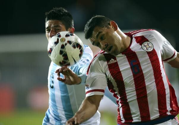 (150614) -- LA SERENA, June 14, 2015 -- Argentina s Facundo Roncaglia (L) fights for the ball with Miguel Samudio of Paraguay during their Group B match at Copa America 2015, in La Serena, Chile, on June 13, 2015. The match ended with a 2-2 draw. ) (SP)CHILE-LA SERENA-COPA AMERICA-ARGENTINA VS PARAGUAY AGENCIAxUNO 