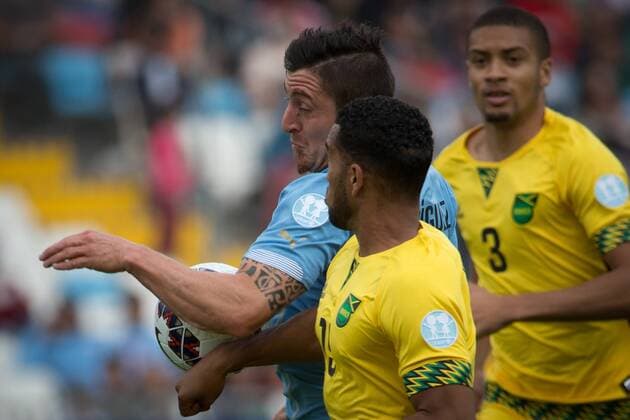 (150614) -- ANTOFAGASTA, June 14, 2015 -- Cristian Rodriguez (L) of Uruguay vies with Cristian Rodriguez of Jamaica during a Group B match at Copa America 2015, in Antofagasta, Chile, on June 13, 2015. Uruguay won 1-0. ) (SP)CHILE-ANTOFAGASTA-COPA AMERICA-GROUP B-URUGUAY VS JAMAICA PedroxMera 