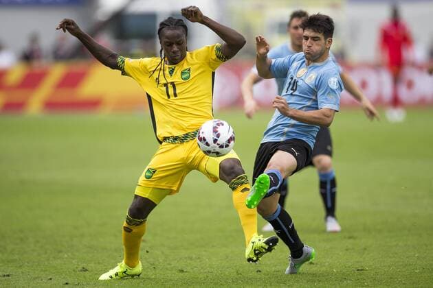 (150614) -- ANTOFAGASTA, June 14, 2015 -- Nicolas Lodeiro (R) of Uruguay vies with Darren Mattocks of Jamaica during a Group B match at Copa America 2015, in Antofagasta, Chile, on June 13, 2015. Uruguay won 1-0. ) (SP)CHILE-ANTOFAGASTA-COPA AMERICA-GROUP B-URUGUAY VS JAMAICA LuisxEcheverria 