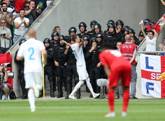 Slovenia s Milivoje Novakovic celebrates scoring his sides opening goal in front of the riot police Slovenia v England - World Cup 2018 Qualifier- Stozice Stadium - Slovenia - 14th June 2015 - Picture David Klein Sportimage EDITORIAL USE ONLY. No use with unauthorised audio, video, data, fixture lists, club league logos or live services. Online in-match use limited to 120 images, no video emulation. No use in betting, games or single club league player publications.