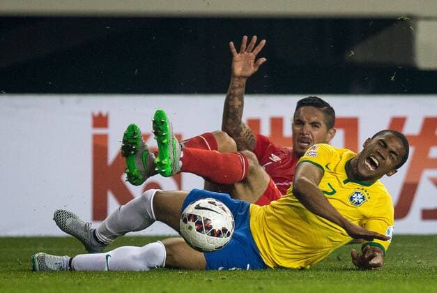 Brazil vs. Peru TEMUCO, AR - 06 14 2015: BRAZIL PERU X - J. Vargas of Peru ball dispute with Douglas Costa from Brazil during the match between Brazil vs Peru, valid for the first round of the first phase of Group C of the Copa America 2015 held at the Municipal Stadium Germ?n Becker. (Photo: Marcelo Machado de Melo FotoArena)  MarceloxMachadoxdexMelo