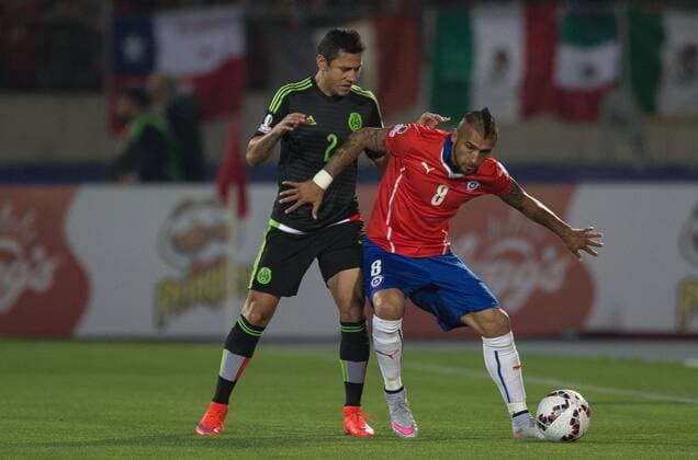 Chile-Mexico SANTIAGO, SC - 15 06 2015: CHILE X MEXICO - J. Dominguez of Mexico and Arturo Vidal of Chile during match between Chile-Mexico, valid for the second round of the first group phase of the Copa America 2015 held at the National Stadium Julio Mart?nez Pr?danos. (Photo: Marcelo Machado de Melo FotoArena)  MarceloxMachadoxdexMelo