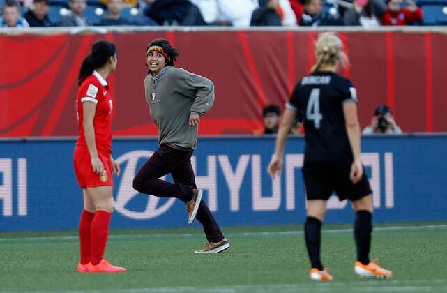 WINNIPEG, June 15, 2015 -- A man runs into the pitch during the Group A match between China and New Zealand at the Winnipeg Stadium in Winnipeg, Canada, on June 15, 2015. The match ended with a 2-2 draw. China advanced to the round of 16. ) (SP)CANADA-WINNIPEG-FIFA WOMEN S WORLD CUP-CHN VS NZL WangxLili 