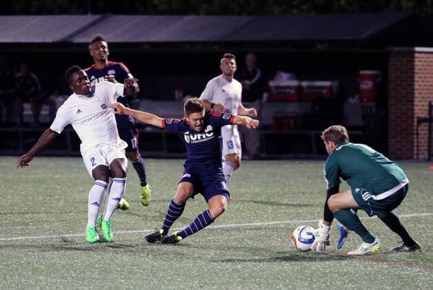 June 17, 2015: New England Revolution midfielder Kelyn Rowe (11) held up by Charlotte Independence defender Mechack Jerome (2) enough for Charlotte Independence goalkeeper Hunter Gilstrap (1) to get the ball. The Charlotte Independence defeated the New England Revolution MLS Fussball Herren USA 1-0 in a fourth round Lamar Hunt US Open Cup match at Harvard s Soldiers Field Soccer Stadium SOCCER: JUN 17 US Open Cup - Fourth Round - Charlotte Independence at Revolution Icon482150617027 EDITORIAL USE ONLY