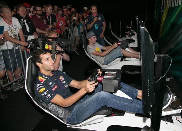 FORMULA 1 - GP of Austria 2015 SPIELBERG,AUSTRIA,18.JUN.15 - MOTORSPORTS, FORMULA 1 - Grand Prix of Austria, Red Bull Ring, preview. Image shows Daniel Ricciardo (AUS Infiniti Red Bull Racing) and Hakki jr. at the gamezone. GEPAxpictures xHaraldxSteiner