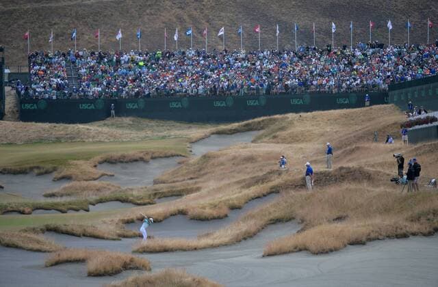 Rory McIlroy hits his ball in the sand on the 18th hole of the 115th U.S. Open Championship at Chambers Bay on June 18, 2015 in University Place, Washington.  SEA20150618252 KEVINxDIETSCH