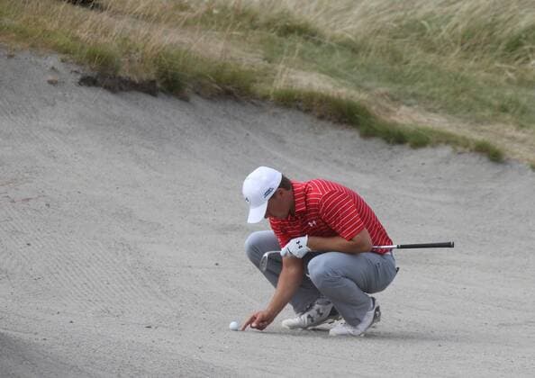 Jordan Spieth checks out his lie in the sand on the ninth hole of round one of the 115th U.S. Open Championship at Chambers Bay on June 18, 2015 in University Place, Washington.  SEA201506182115 JIMxBRYANT
