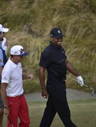 June 18, 2015..Tiger Woods laughs with Rickie Fowler after his ball rolled close to the hole and lead to an improbable up and down save from a plugged lie in a bunker next to the10th green during round 1 at the U.S. Open at Chambers Bay, University Place, Washington. . .George Holland Cal Media PGA Golf Herren Tour 2015: US Open Round 1 JUN 18 - ZUMAch4_