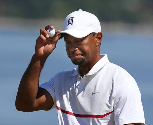 Tiger Woods tips his hat to the gallery altering sinking a putt on the 17th green in the second round of the 115th U.S. Open Championship at Chambers Bay on June 19, 2015 in University Place, Washington.  SEA20150619031 JIMxBRYANT