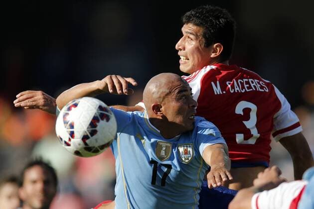 Football , Uruguay v Paraguay. Copa America Championship 2015 . Uruguay s player Egidio Arevalo, left , battles for the ball against Marcos Cáceres of Paraguay during the group B football match of the 2015 Copa America at the La Portada stadium in Santiago.. 20 06 2015 Andres Pina Photosport Uruguay v Paraguay, Copa America 2015. 