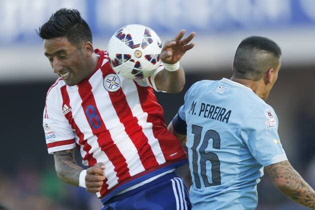 Football , Uruguay v Paraguay Copa America 2015 . Paraguay s Lucas Barrios, left, battles for the ball agains Maximiliano Pereira of Uruguay during the match of group B of the 2015 Copa America at La Serena stadium. Rancagua, Chile. 20 06 2015 Marcelo Hernandez Photosport Uruguay v Paraguay, Copa America 2015. 