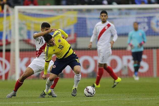 Football, Colombia v Peru. Copa America 2015. Colombia s player James Rodriguez, center, battles for the ball during the Copa America Group C, at German Becker stadium. Temuco. 21 06 2015 AlejandroZonez Photosport Colombia v Peru, Copa America 2015. 