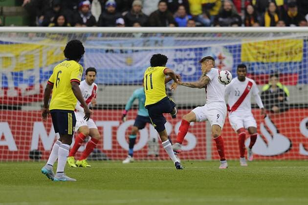 Football, Colombia v Peru. Copa America 2015. Colombia s player Juan Guillermo Cuadrado, center, battles for the ball against José Paolo Guerrero of Peru during the Copa America Group C, at German Becker stadium. Temuco. 21 06 2015 AlejandroZonez Photosport Colombia v Peru, Copa America 2015. 