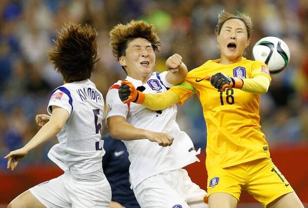 Park Eun Sun of South Korea clashes with her goalie Kim Jung Mi during Round 16 match between France and South Korea at Olympic Stadium in Montreal, Canada on June 21, 2015. South Korea lost the match 0-3. ) (SP)CANADA-MONTREAL-FIFA WOMEN S WORLD CUP-ROUND 16-FRA VS KOR WangxLili 