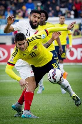 Colombia s James Rodriguez (front) vies with Josepmir Ballon of Peru during a Group C match at the 2015 America Cup, held at German Becker in Temuco, Chile, July 21, 2015. The match ended with 0-0. Pedro Mera) (vf) (SP)CHILE-TEMUCO-COPA AMERICA-COLOMBIA VS PERU LuisxEcheverria 