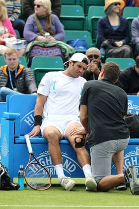 22.06.2015. Nottingham, England. Aegon Nottingham Open Tennis Tournament. Malek Jaziri (Tunisia) getting treatment for his knee during his match against Kyle Edmund (Great Britain) xDavidxKissmanx  ActionPlus11634207