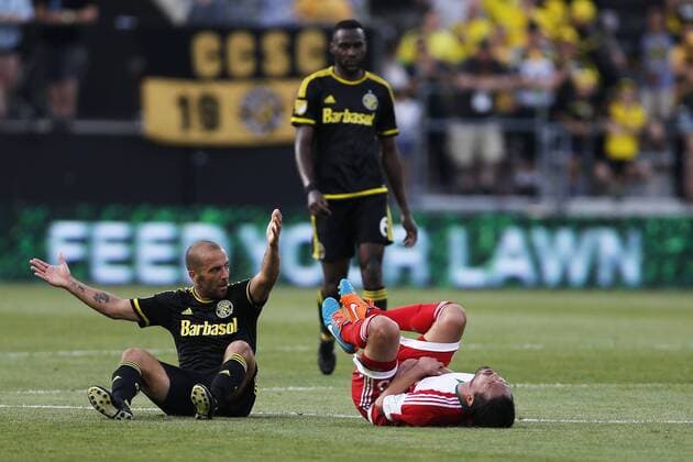 June 24, 2015 - Columbus, OH, USA - The Columbus Crew s Federico Higuain, left, reacts after colliding with the New England Revolution s Daigo Kobayashi during the first half at Mapfre Stadium in Columbus, Ohio, on Wednesday, June 24, 2015. New England at Columbus - ZUMAm67_
