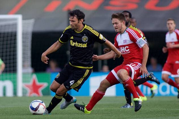 June 24, 2015 - Columbus, Ohio, U.S - Columbus Crew SC defender Michael Parkhurst (4) moves with the ball away from New England Revolution midfielder Kelyn Rowe (11) in the first half of the match between New England Revolution and Columbus Crew SC at Mapfre Stadium, Columbus, Ohio. MLS Fussball Herren USA 2015 - June 24 - New England at Columbus - ZUMAs304