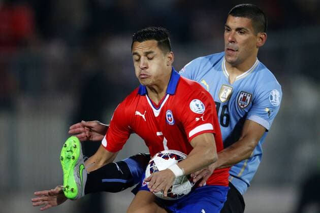 Copa America Championship 2015 . Chile s player Alexis Sanchez, center, battles for the ball against Maximiliano Pereira of Uruguay during the group A of the 2015 Copa America football match at the National stadium in Santiago, Chile. 24 06 2015 Andres Pina Photosport Chile v Uruguay, Copa America 2015. 