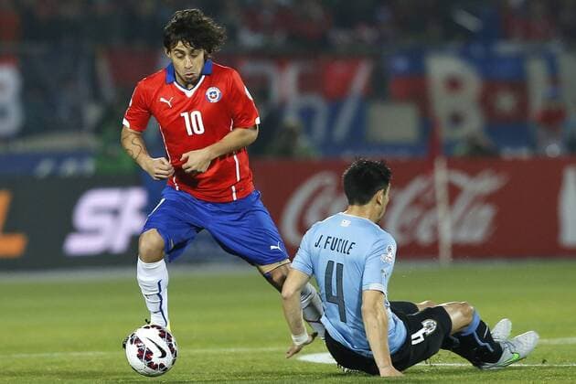 Chile v Uruguay. Copa America 2015 . Chile s Jorge Valdivia, left, battles for the ball against Jorge Fucile of Uruguay during the match of quarter finals of the 2015 Copa America at La Serena stadium. Santiago, Chile. 24 06 2015 Marcelo Hernandez Photosport Chile v Uruguay, Copa America 2015. 