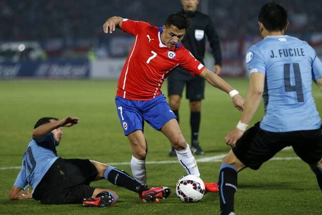 Copa America Championship 2015 . Chile s player Alexis Sanchez, center, battles for the ball against the defense of Uruguay during the group A of the 2015 Copa America football match at the National stadium in Santiago, Chile. 24 06 2015 Andres Pina Photosport Chile v Uruguay, Copa America 2015. 