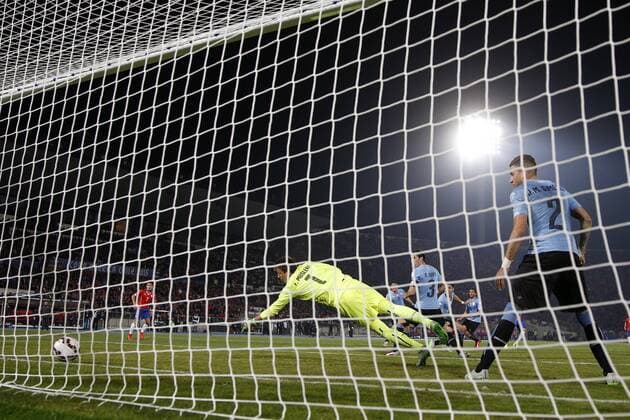 Copa America Championship 2015 . Chile s player Mauricio Isla, covered, scores against Uruguay during the group A of the 2015 Copa America football match at the National stadium in Santiago, Chile. 24 06 2015 Andres Pina Photosport Chile v Uruguay, Copa America 2015. 