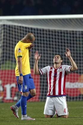 Paraguay s Pablo Aguilar (R) reacts during a quarter-final match between Brazil and Paraguay in Concepcion, Chile, June 27, 2015. Paraguay defeated Brazil 4-3 on penalties after a 1-1 draw thus qualified to the semi-final round. ) (vf) (SP)CHILE-CONCEPCION-AMERICAN CUP-QUARTERFINAL-BRAZIL VS PARAGUAY GuillermoxArias 