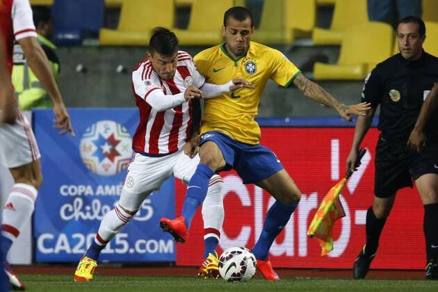 Football , Brazil v Paraguay. Copa America Championship 2015 . Brazil s player Dani Alves, right, battles for the ball against Edgar Benitez of Paraguay during the 2015 Copa America football championship quarterfinal match at the Ester Roa stadium in Concepcion, Chile. 27 06 2015 Andres Pina Photosport Brasil v Paraguay, Copa America 2015. 