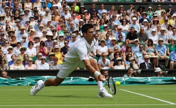 Serbia s Novak Djokovic plays a forehand against Germany s Philipp Kohlschreiber at the 2015 Wimbledon championships, London on June 29, 2015. Djokovic won the match 6-4,6-4,6-4.  LON2015062902 HUGOxPHILPOTT