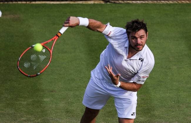 (150702) -- LONDON, Stan Wawrinka of Switzerland serves to Victor Estrella Burgos of the Dominican Republic during the men s singles second round match at 2015 Wimbledon Tennis Championships in London, Britain, July 1, 2015. Wawrinka won 3-0. ) (SP)BRITAIN-LONDON-TENNIS-WIMBLEDON CHAMPIONSHIPS TangxShi 