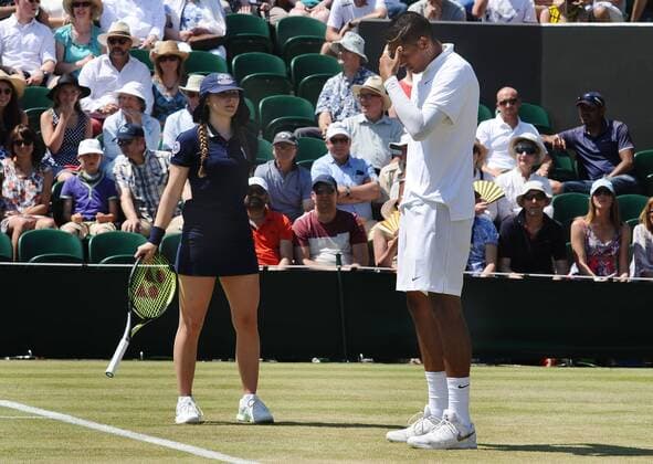 Tennis - 2015 Wimbledon Championships - Week One, Friday Men s Singles, Second Round Nick Kyrgios (AUS) vs. Milos Raonic (CAN) Nick Kyrgios can t believe the bad bounce on Court 2 The Ball girl picks up his racket for him COLORSPORT ANDREW COWIE 