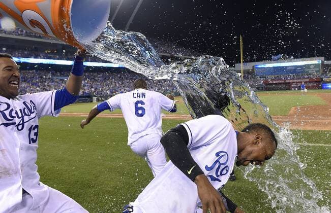 July 3, 2015 - Kansas City, MO, USA - The Kansas City Royals Salvador Perez (13) dumps a water bucket on Jarrod Dyson as Lorenzo Cain (6) runs away after a 3-2 win in 10 innings against the Minnesota Twins on Friday, July 3, 2015, at Kauffman Stadium in Kansas City, Mo. Minnesota at Kansas City - ZUMAm67_