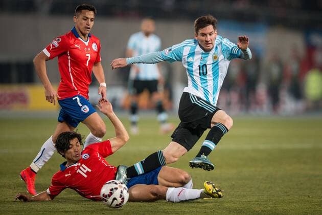 Chile x Argentina SANTIAGO, CHILE - 04 07 2015: CHILE X ARGENTINA - Mat?as Fernandez of Chile dispute ball with Lionel Messi of Argentina during the match between Chile x Argentina, valid for the final of the Copa America 2015 held at the National Stadium Julio Mart?nez Pr?danos. (Photo: Marcelo Machado de Melo FotoArena)  MarceloxMachadoxdexMelo
