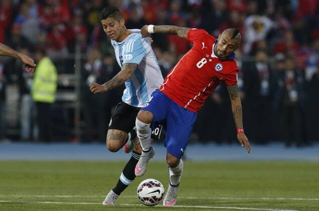 Football, Chile v Argentina. Copa America 2015 . Chile s player Arturo Vidal, right, battles for the ball against Marcos Rojo of Argentina during the finals of the Copa America 2015 football match held at the Nacional stadium in Santiago, Chile. 04 07 2015 Martin Thomas Photosport Chile v Argentina, Copa America 2015. 