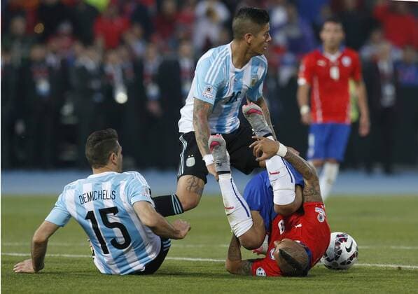 Football, Chile v Argentina. Copa America 2015 . Chile s player Arturo Vidal, right, battles for the ball against Marcos Rojo of Argentina during the finals of the Copa America 2015 football match held at the Nacional stadium in Santiago, Chile. 04 07 2015 Martin Thomas Photosport Chile v Argentina, Copa America 2015. 