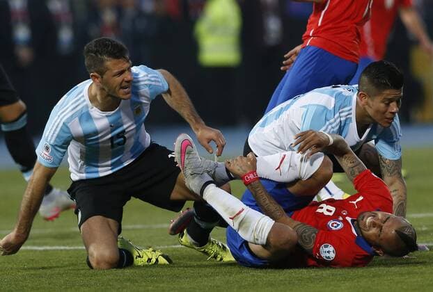 Football, Chile v Argentina. Copa America 2015 . Chile s player Arturo Vidal reacts after being fouled during the finals of the Copa America 2015 football match played against Argentina at the Nacional stadium in Santiago, Chile. 04 07 2015 Martin Thomas Photosport Chile v Argentina, Copa America 2015. 