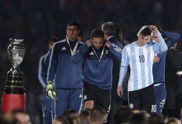 (150705) -- SANTIAGO, July 4, 2015 -- Lionel Messi (R) of Argentina takes off his medal after the final match of the Copa America Chile 2015 against Chile, at the National Stadium, in Santiago, capital of Chile, on July 4, 2015. Chile won the final match of the Copa America 2015 against Argentina after the penalty kick 4-1. ) (ce) (SP)CHILE-SANTIAGO-COPA AMERICA-FINAL-CHILE VS ARGENTINA GuillermoxArias 