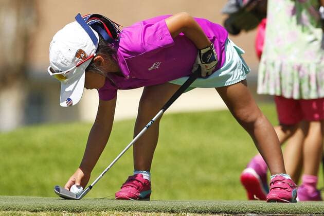 July 14, 2015 - San Diego, California, United States - July 14, 2015_San Diego, CA_USA_ Anna Fang of Escondido, tees up a shot during the Junior World Golf Championships 6 and under division at Colina Park Golf Course. Photo by Anna Fang of Escondido, tees up a shot during the Junior World Golf Championships 6 and under division at Colina Park Golf Course. - ZUMAs44_