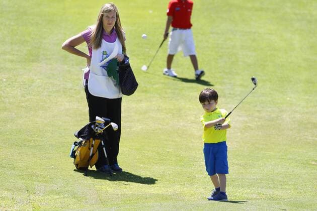July 14, 2015 - San Diego, California, United States - July 14, 2015_San Diego, CA_USA_ James Grimes III, 4, chips the ball as his mom Nicole looks on during the first round of the Junior World Golf Championships 6 and under division at Colina Park Golf Course. Photo by James Grimes III, 4, chips the ball as his mom Nicole looks on during the first round of the Junior World Golf Championships 6 and under division at Colina Park Golf Course. - ZUMAs44_