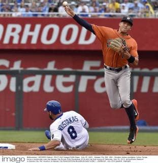 July 25, 2015 - Kansas City, MO, USA - Houston Astros shortstop Carlos Correa turns a double play over the Kansas City Royals Mike Moustakas (8) to end the first inning on Saturday, July 25, 2015, at Kauffman Stadium in Kansas City, Mo. Houston at Kansas City - ZUMAm67_