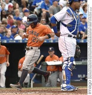 July 25, 2015 - Kansas City, MO, USA - The Houston Astros Jose Altuve (27) scores behind Kansas City Royals catcher Salvador Perez on a sacrifice fly by Carlos Correa in the sixth inning on Saturday, July 25, 2015, at Kauffman Stadium in Kansas City, Mo. Houston at Kansas City - ZUMAm67_