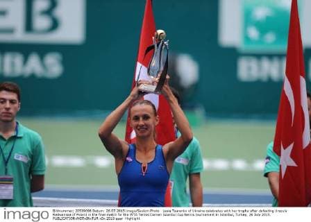 Lesia Tsurenko of Ukraine celebrates with her trophy after defeating Urszula Radwanska of Poland in the final match for the WTA Tennis Damen Istanbul Cup tennis tournament in Istanbul, Turkey, 26 July 2015. 