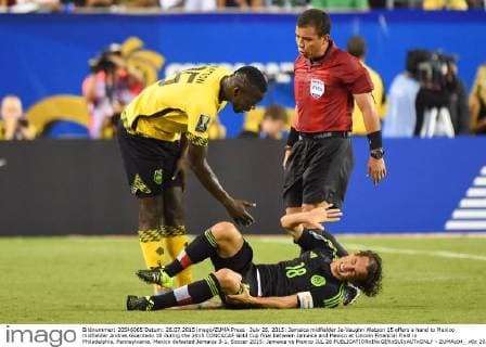 July 26, 2015: Jamaica midfielder Je-Vaughn Watson 15 offers a hand to Mexico midfielder Andres Guardado 18 during the 2015 CONCACAF Gold Cup final between Jamaica and Mexico at Lincoln Financial Field in Philadelphia, Pennsylvania. Mexico defeated Jamaica 3-1. Soccer 2015: Jamaica vs Mexico JUL 26 - ZUMAc04_
