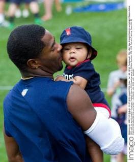 July 30, 2015; Foxborough, MA, USA: New England Patriots cornerback Malcom Butler (21) with his son during NFL American Football Herren USA training camp at Gillette Stadium. NFL 2015: Patriots Training Camp JUL 30 - ZUMAc04_