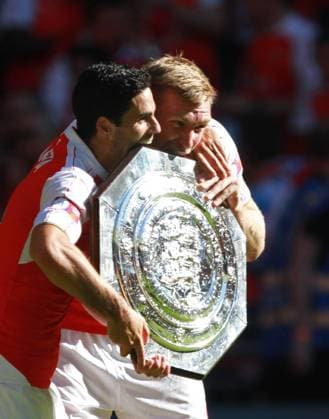 FA Community Shield - Arsenal v Chelsea . . London, UK . . 02.08.2015 Mikel Arteta (A) and Per Mertesacker (A) celebrate with the Shield. 
