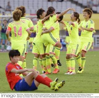 Japan play South Korea in women s East Asian Cup Emi Nakajima of Japan (C) is held up by her teammate after scoring the opening goal during the first half of a game against South Korea in the women s tournament of the East Asian Cup in Wuhan, China, on Aug. 4, 2015. 