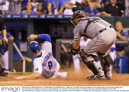 zzJanuary 10, 2012: Mike Moustakas 8 of the Kansas City Royals slides safely past the tag from Tyler Flowers 21 of the Chicago White Sox for the first run of the game in the fifth inning during the MLB Baseball Herren USA game between the Chicago White Sox and the Kansas City Royals at Kauffman Stadium in Kansas City MO MLB 2015: White Sox vs Royals AUG 10 - ZUMAc04_